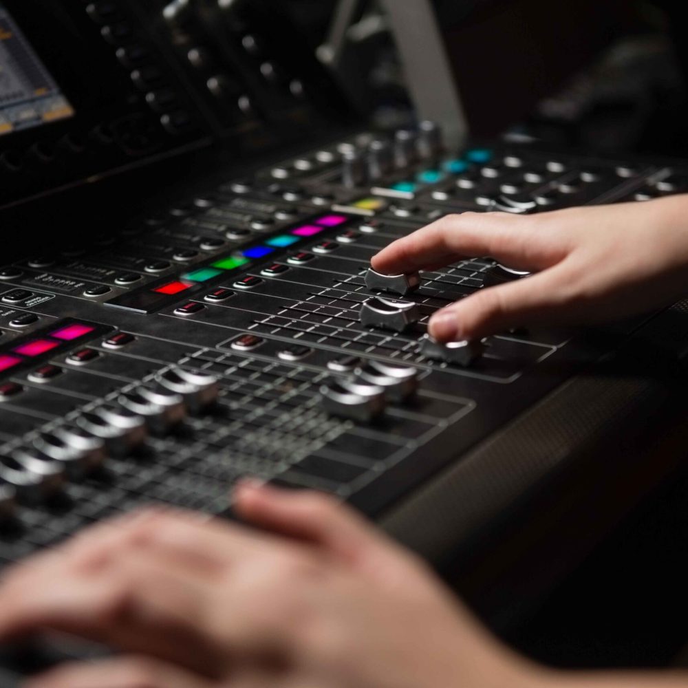 hands-of-female-audio-engineer-using-sound-mixer-2025-04-04-06-42-10-utc-1-scaled